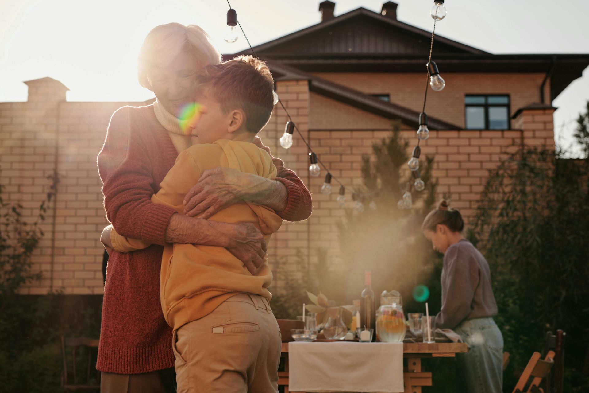 Retired woman embraces grandchild